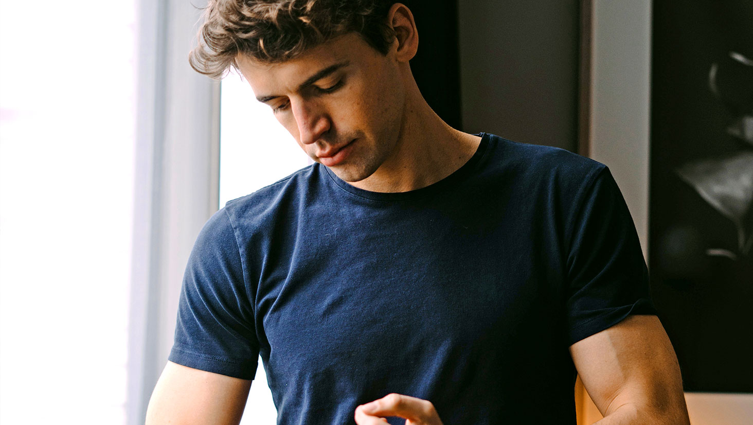 Man wearing dark blue shirt Man wearing dark blue shirt